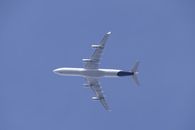 A commercial aircraft in flight against a clear sky