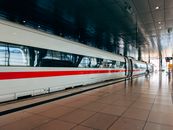 A high-speed passenger train at a station platform